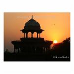 The orange sky is joined by the sun as a new day begins. Agra, India