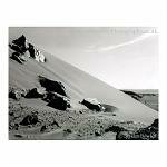 B&W shot of rocks on a sand dune in the Sousseslvei region of Namibia, Africa.