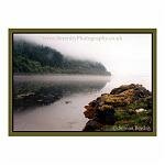A morning mist shrouds a Scottish Loch.