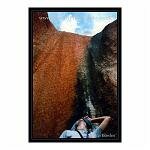 Figure looking up at Ayres Rock - Uluru - Australia.
