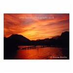 Stunning red and orange sunset across the river in Vang Vien, Laos