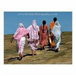 Four women walk up the hill to pray at the Jain Temple. Sravanabelagola, India.