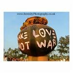 A man in fancy dress - quite literally a pot head - makes a statement at Arambol Carnival, Goa, India.
