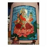 Varanasi, City of Light - the holiest of Indian cities. Here a holy man site dwarfed by a painting of a God.