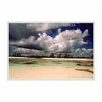 Blue sky and storm clouds over a white sand beach. Kenya, Africa.