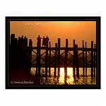 The sihouette of monks standing on U Bein's Bridge, near Mandalay, Myanmar (formerly Burma).