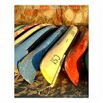 Colourful canoes stacked against a wall. Kalbarri, Western Australia.