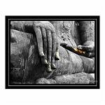 Statue of Buddha, with garlands of flowers on the hand. Colour composite. Sukkhothai, Thailand.